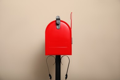 Closed red letter box against beige background