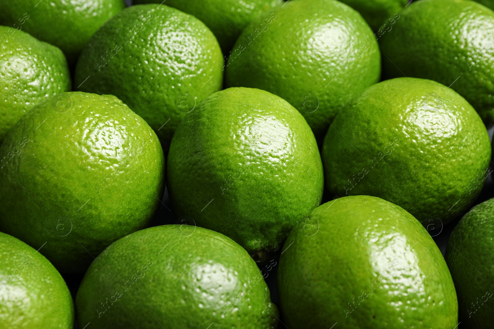 Photo of Fresh ripe green limes as background, closeup