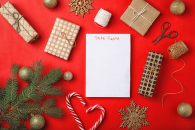 Photo of Flat lay composition with childish letter to Santa Claus and Christmas decoration on color background