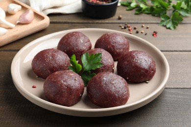 Photo of Many fresh raw meatballs on wooden table