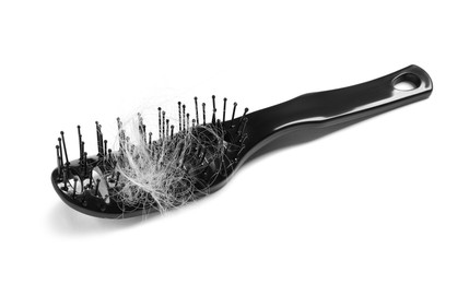 Photo of Brush with lost hair isolated on white