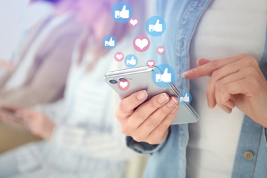 Image of Young woman using modern smartphone indoors, closeup