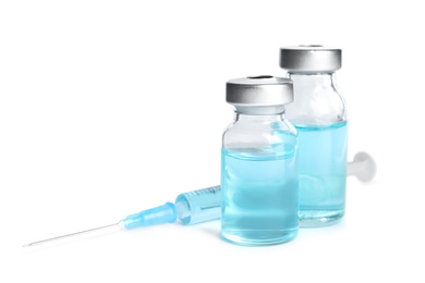 Photo of Vials and syringe on white background. Vaccination and immunization