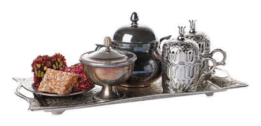 Photo of Tea and Turkish delight served in vintage tea set on white background