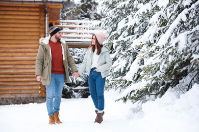Photo of Lovely couple spending time together on snowy day. Winter vacation