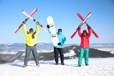 Friends with equipment at ski resort. Winter vacation