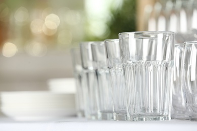 Photo of Set of empty glasses on table indoors