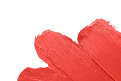 Photo of Red lipstick smears on white background, closeup. Space for text