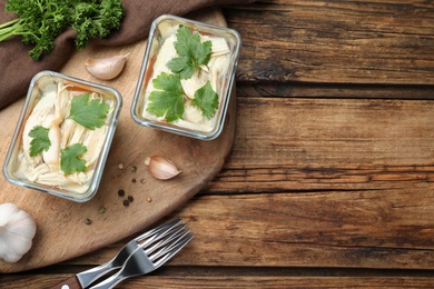 Photo of Delicious chicken aspic served on wooden table, flat lay. Space for text