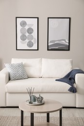 Photo of Stylish living room interior with white sofa and small coffee table