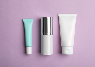 Photo of Set of luxury cosmetic products on violet background, flat lay