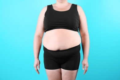 Photo of Fat woman on color background, closeup. Weight loss