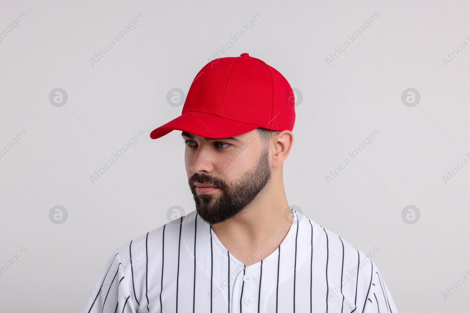 Photo of Man in stylish red baseball cap on white background