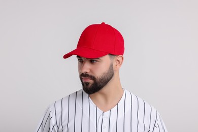 Photo of Man in stylish red baseball cap on white background