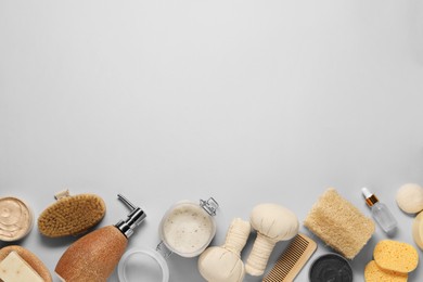 Photo of Bath accessories. Flat lay composition with personal care products on light grey background, space for text