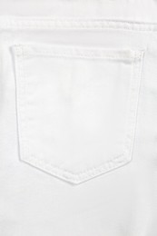 Photo of White jeans with back pocket as background, closeup