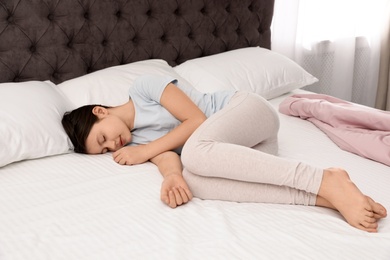 Photo of Cute little girl sleeping in bed at home