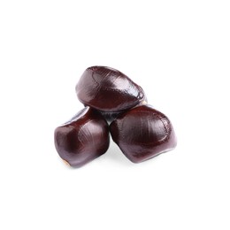 Photo of Three brown tamarind seeds on white background