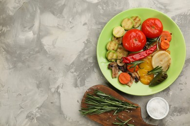 Photo of Delicious grilled vegetables served on light grey table, flat lay. Space for text
