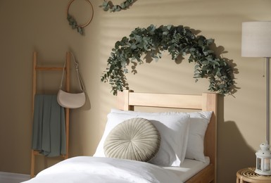 Photo of Stylish bedroom decorated with beautiful eucalyptus garland