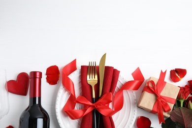 Photo of Romantic table setting on white wooden background, flat lay with space for text. Valentine's day celebration