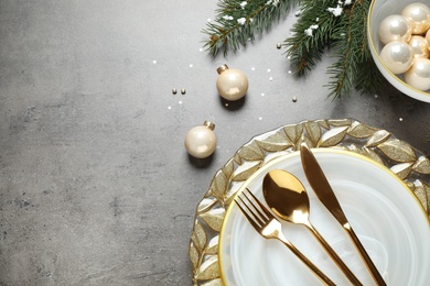 Photo of Christmas table setting on grey background, flat lay. Space for text