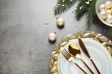 Christmas table setting on grey background, flat lay. Space for text