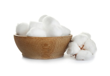 Photo of Balls of fluffy cotton in wooden bowl and flower on white background