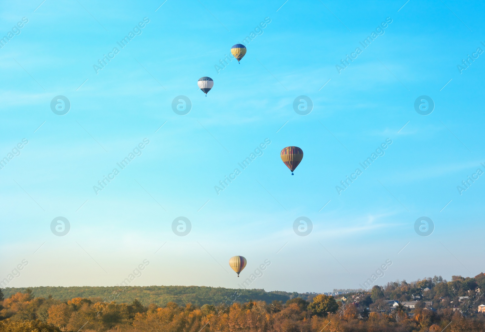 Photo of Colorful hot air balloons flying over countryside