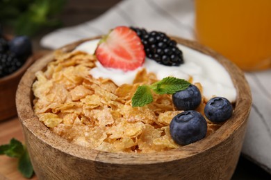 Photo of Delicious crispy cornflakes, yogurt and fresh berries in bowl, closeup. Healthy breakfast
