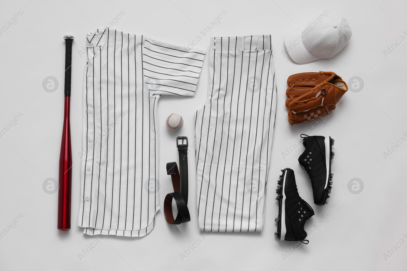 Photo of Flat lay composition with baseball uniform on white background