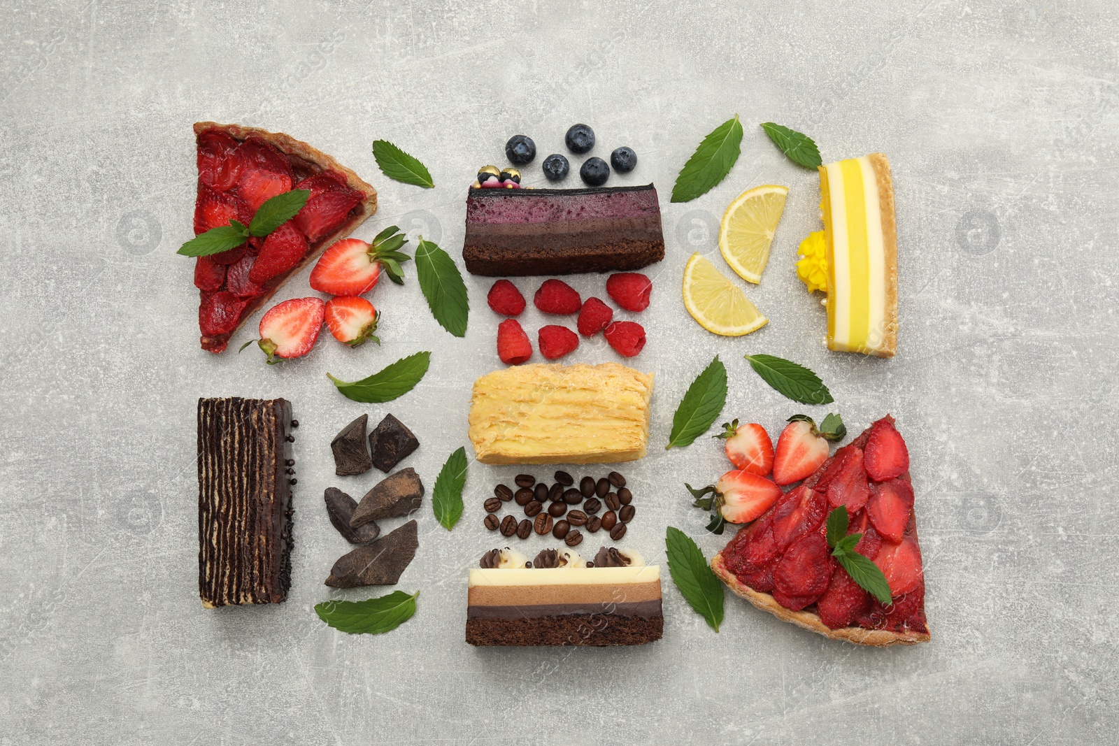 Photo of Flat lay composition with different tasty cakes on light grey table