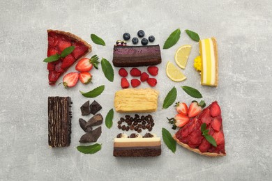 Flat lay composition with different tasty cakes on light grey table