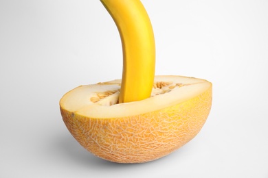 Fresh banana and melon on white background. Sex concept
