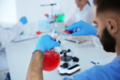 Photo of Medical student working in modern scientific laboratory, closeup