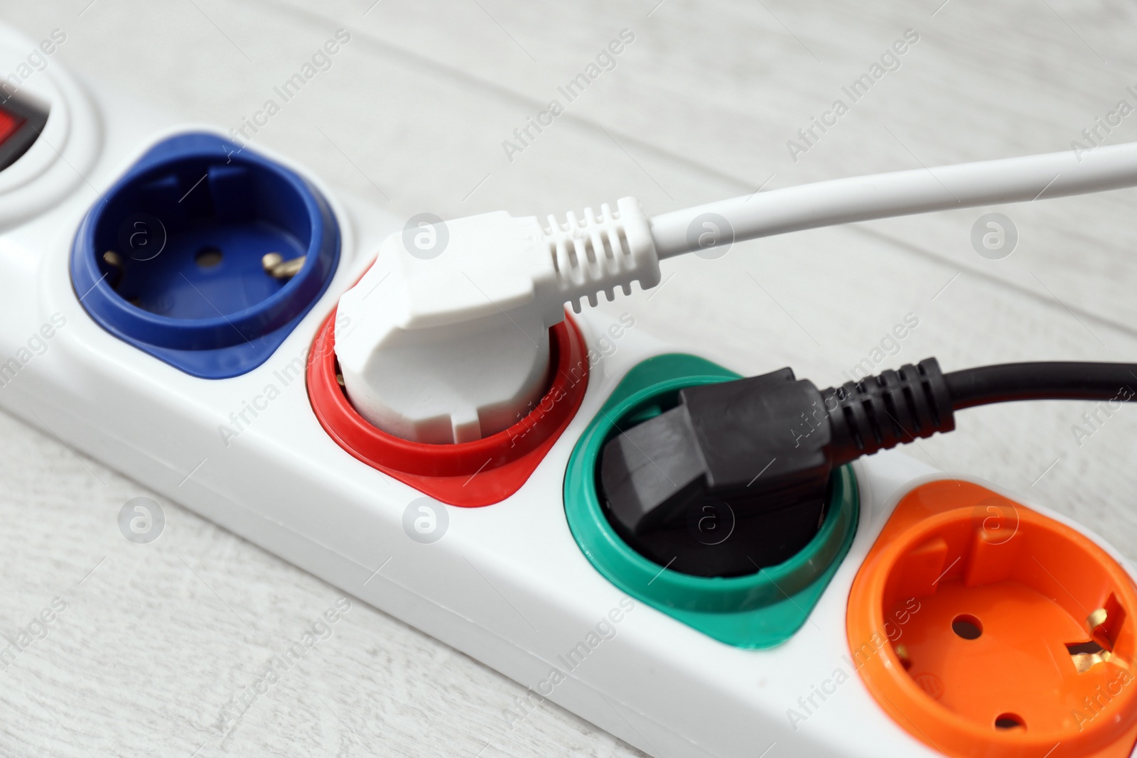 Photo of Extension cord on floor, closeup. Electrician's professional equipment