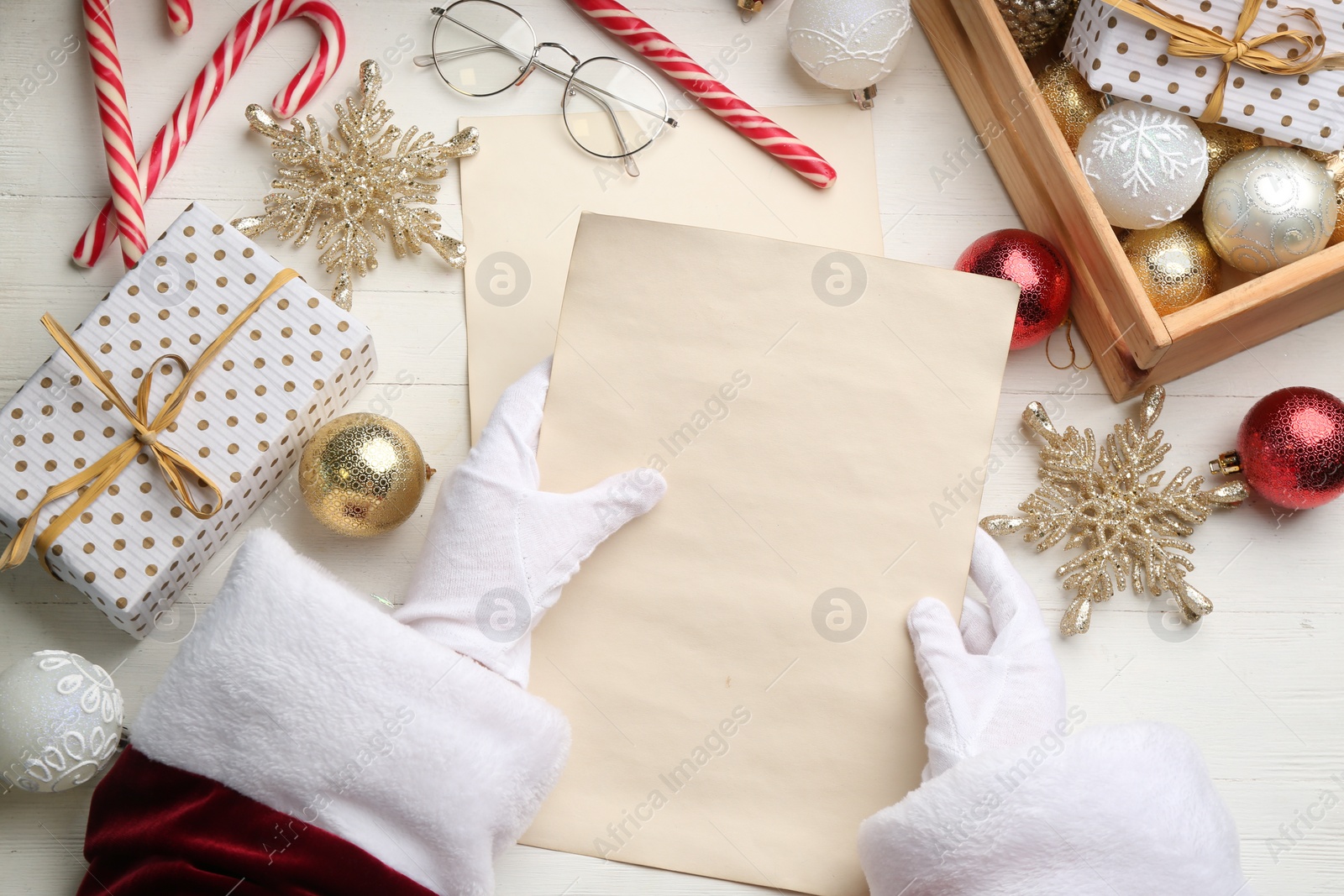 Photo of Santa letter at white wooden table, top view