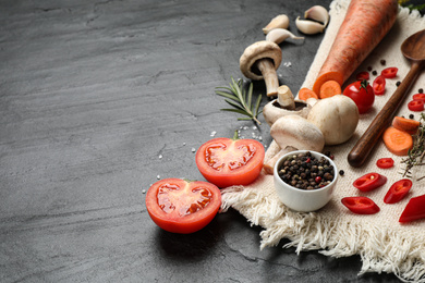 Photo of Fresh products on black table, space for text. Healthy cooking