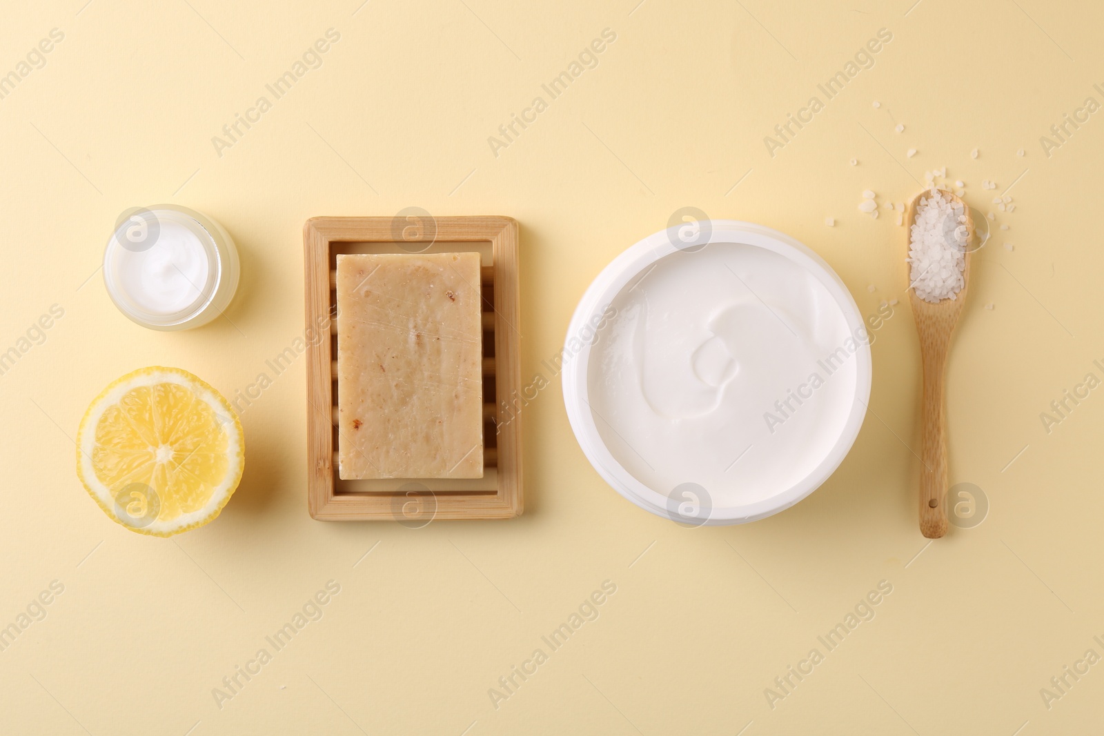 Photo of Flat lay composition with jars of cream on beige background. Body care product