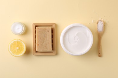 Photo of Flat lay composition with jars of cream on beige background. Body care product