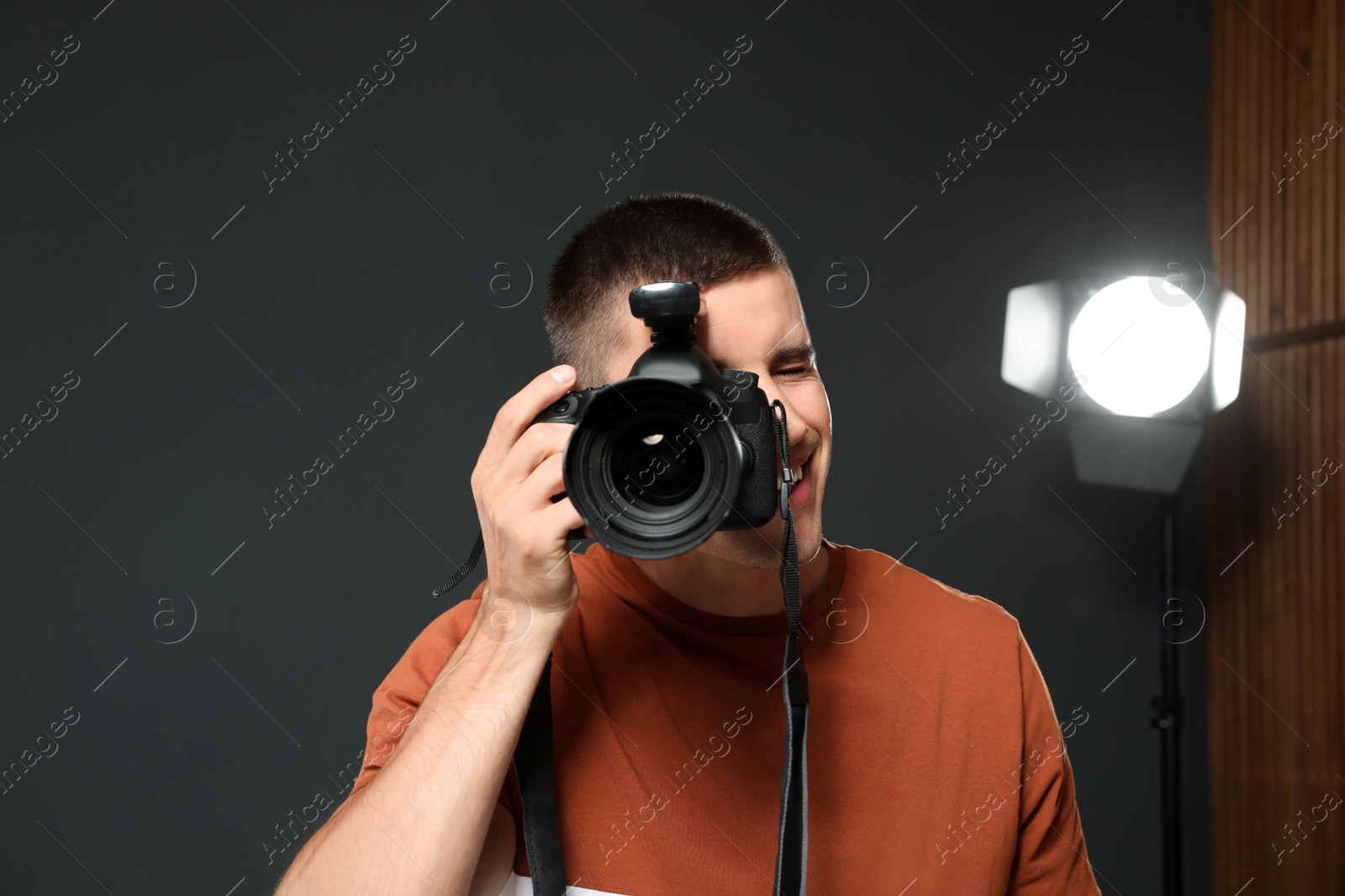 Photo of Professional photographer taking picture in modern studio