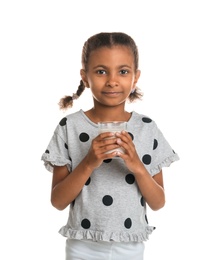 Adorable African-American girl with glass of milk on white background