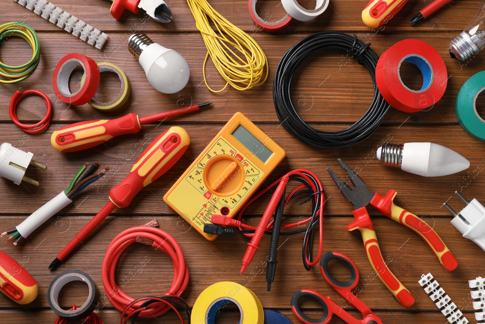 Photo of Flat lay composition with electrician's tools and accessories on wooden background