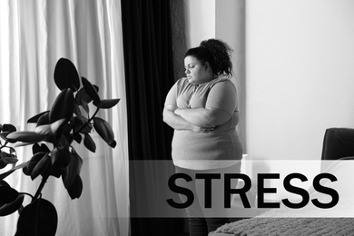 Overweight woman suffering from depression at home and word STRESS