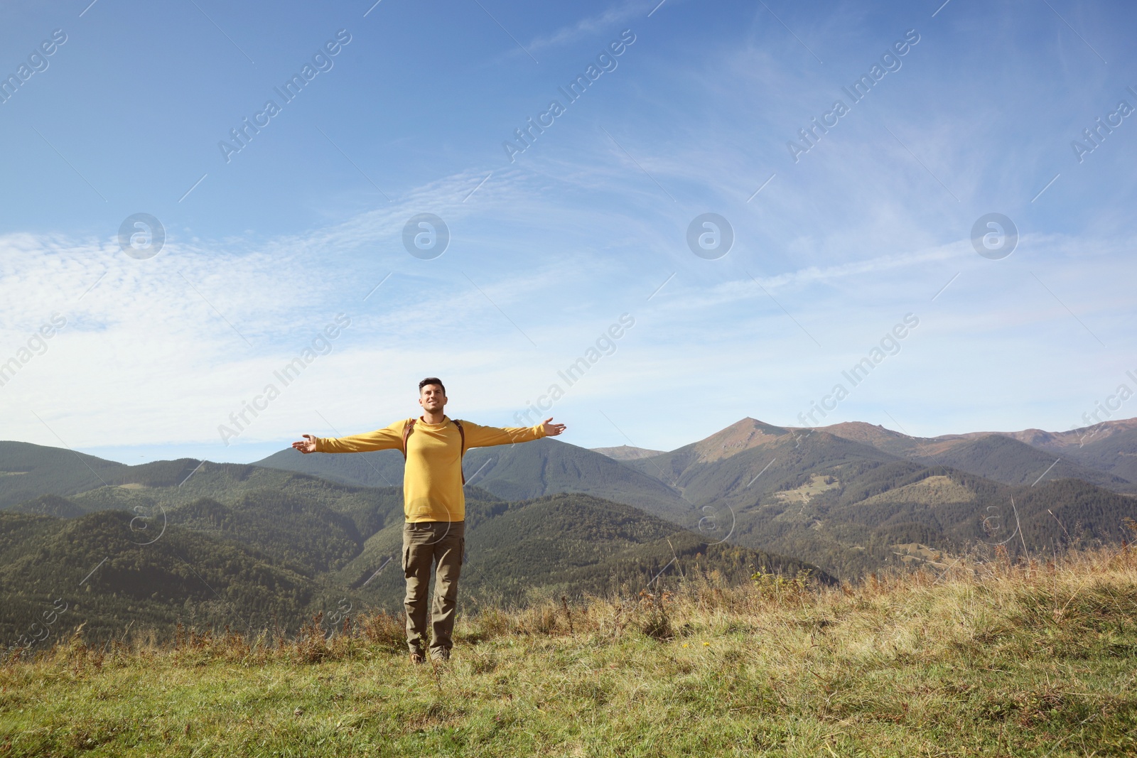 Photo of Man enjoying beautiful mountain landscape on sunny day