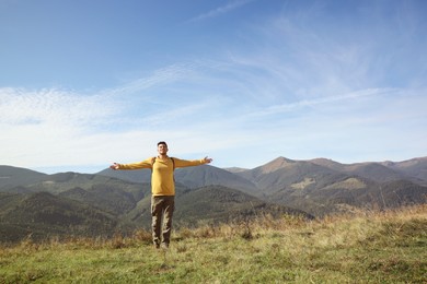 Photo of Man enjoying beautiful mountain landscape on sunny day