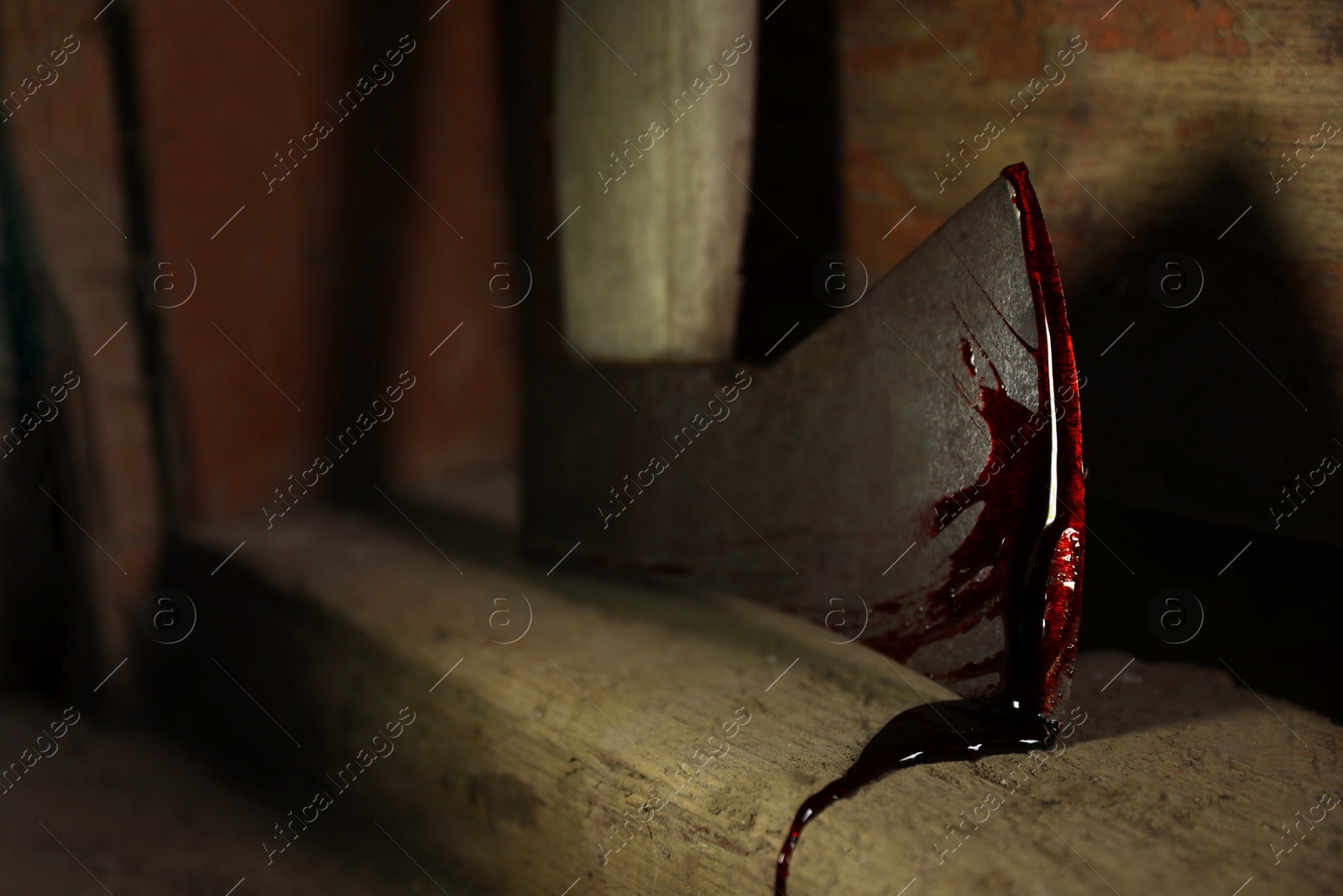 Photo of Axe with blood on wooden threshold indoors, closeup