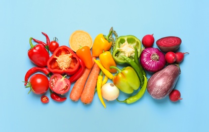 Flat lay composition with fresh vegetables on light blue background