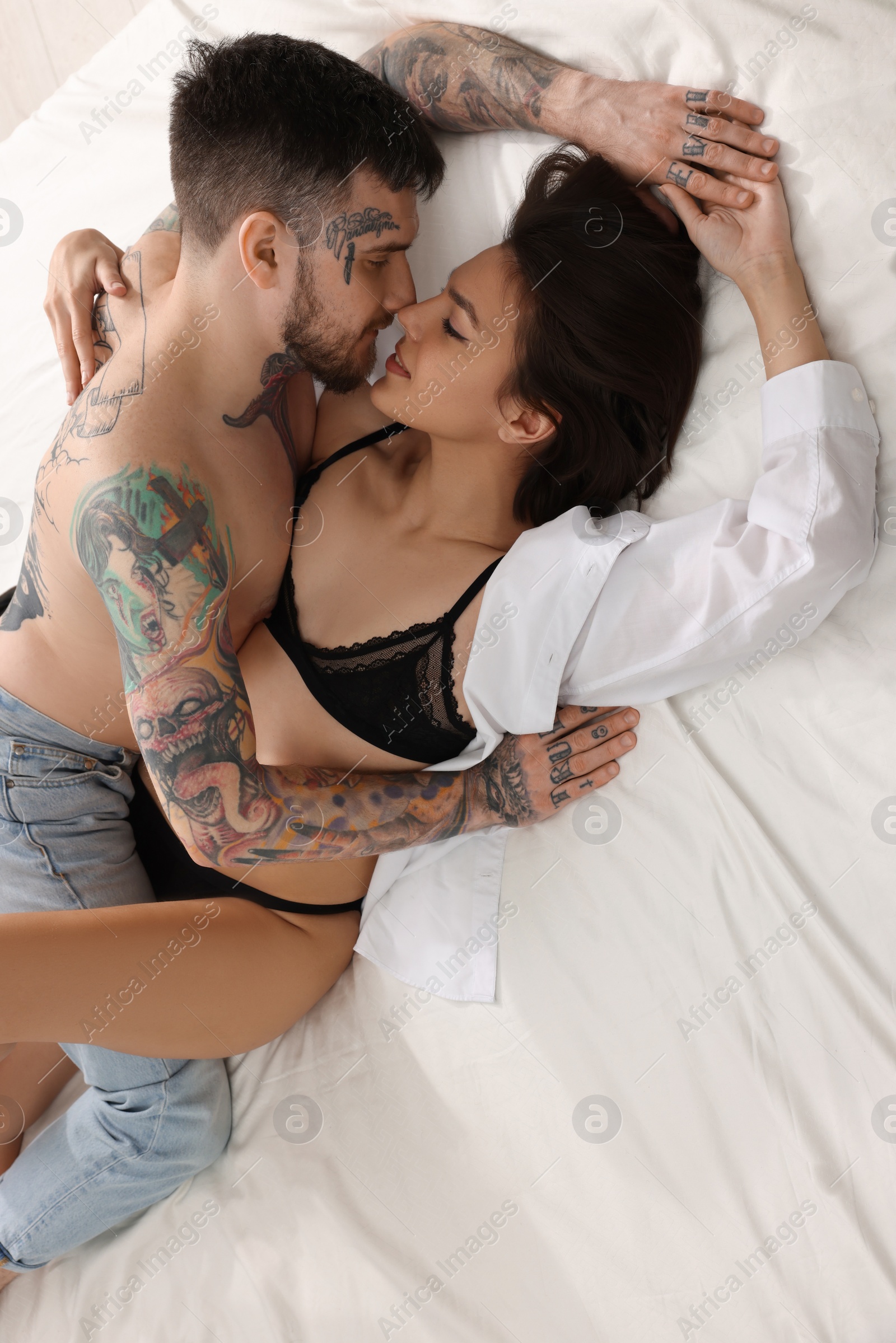 Photo of Passionate couple having sex on white bed