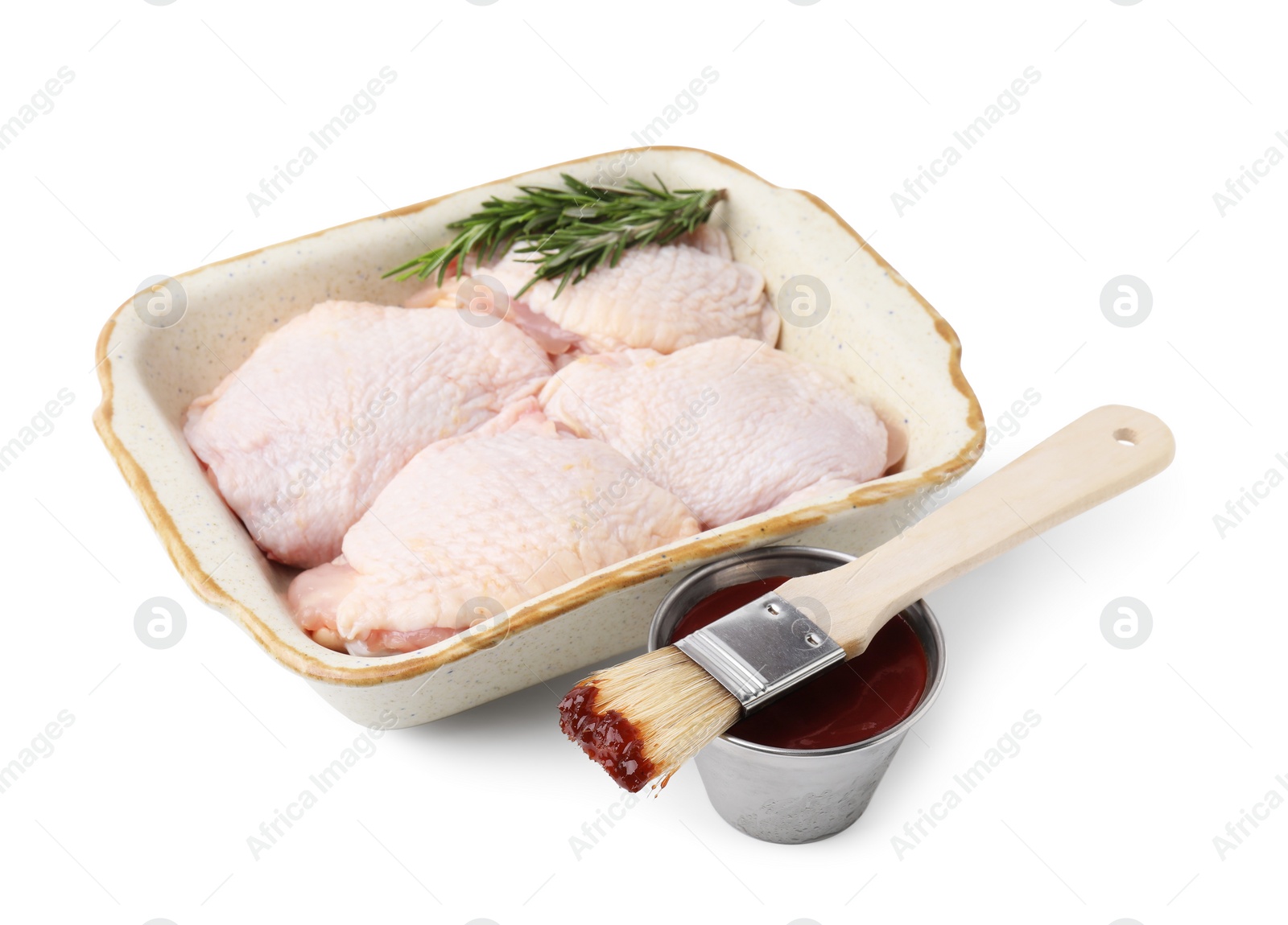 Photo of Marinade, basting brush, raw chicken and rosemary isolated on white